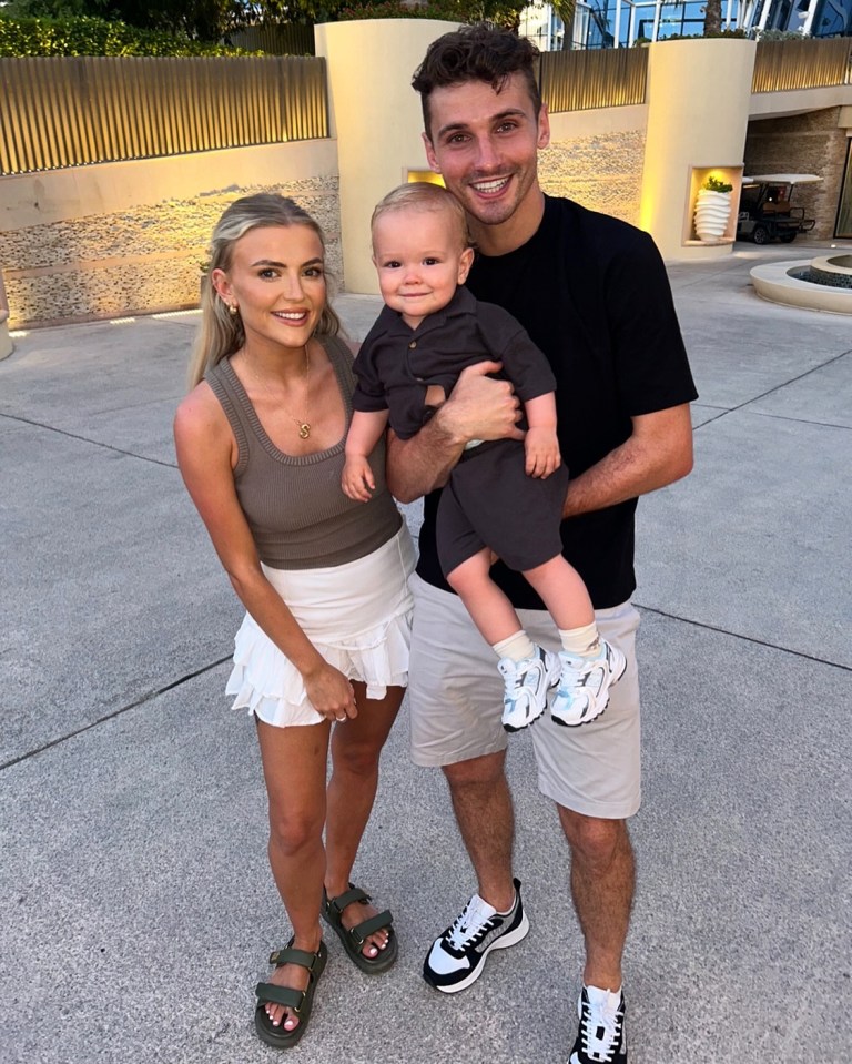 Family photo of a man, woman, and baby.