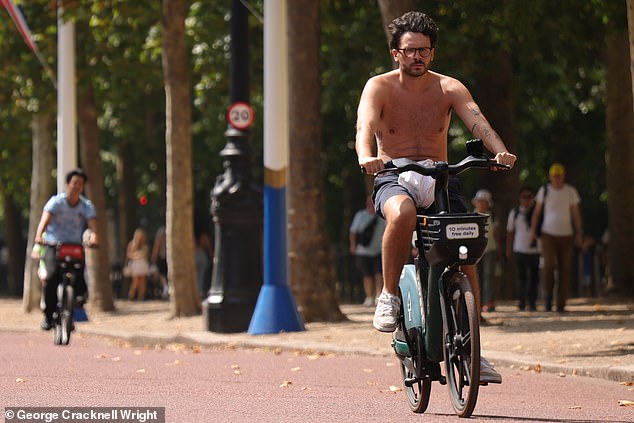 LONDON: A cyclist ditches his shirt as he peddles along the Mall in searing heat on Sunday