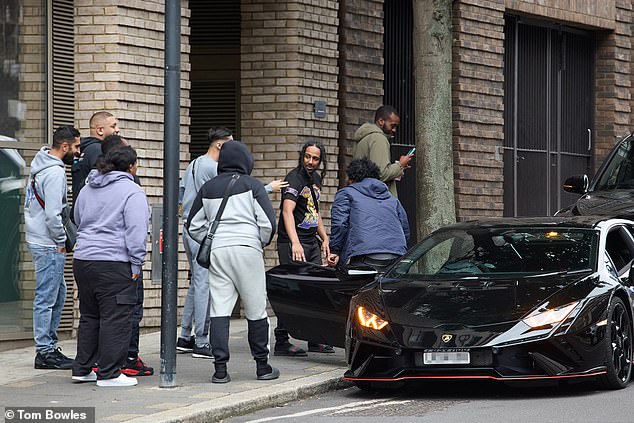 Pictured: a former prisoner celebrates his early release with friends who picked him up in a Lamborghini