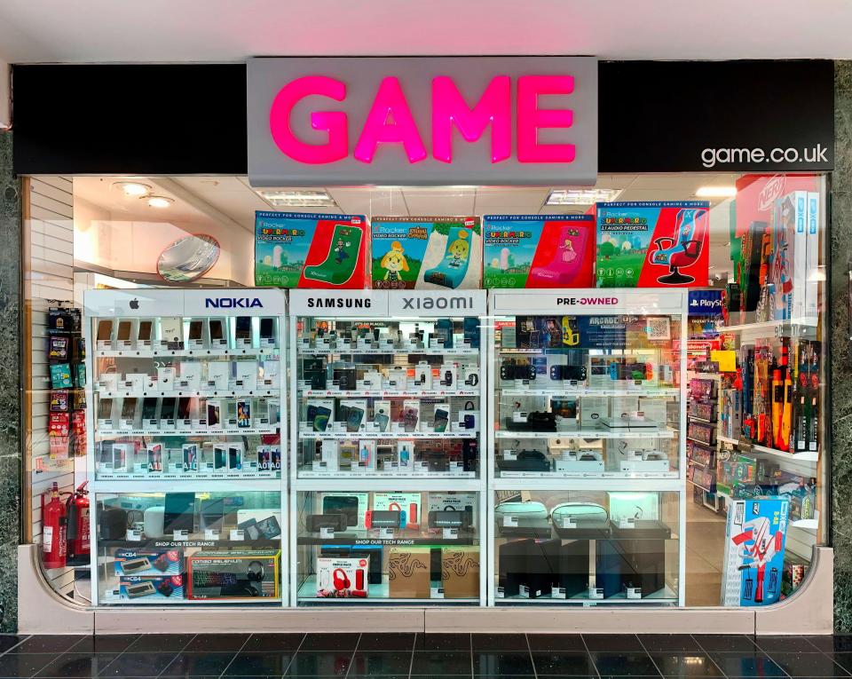 Game retail store storefront with electronics and games on display.