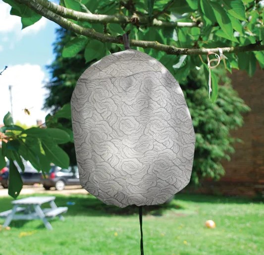 Wasp decoy nest hanging from a tree branch.