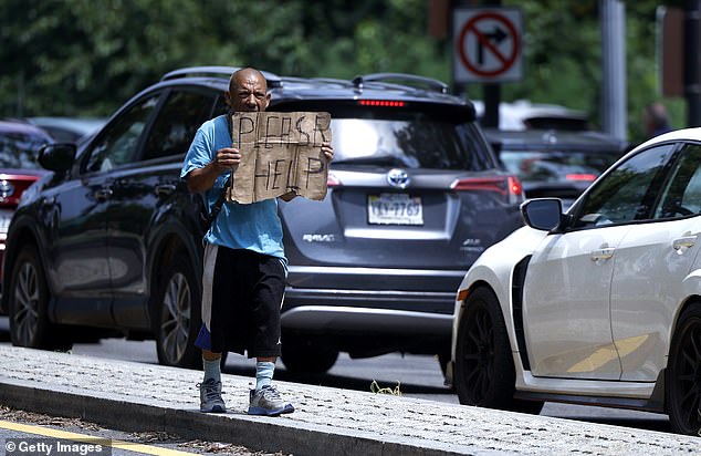 A person asks for help along the Rock Creek Parkway last month in Washington, DC