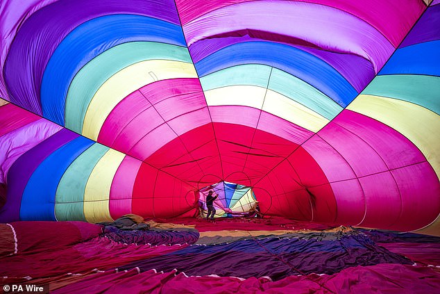 The inside of a pink and purple hot air balloon about to be blown up