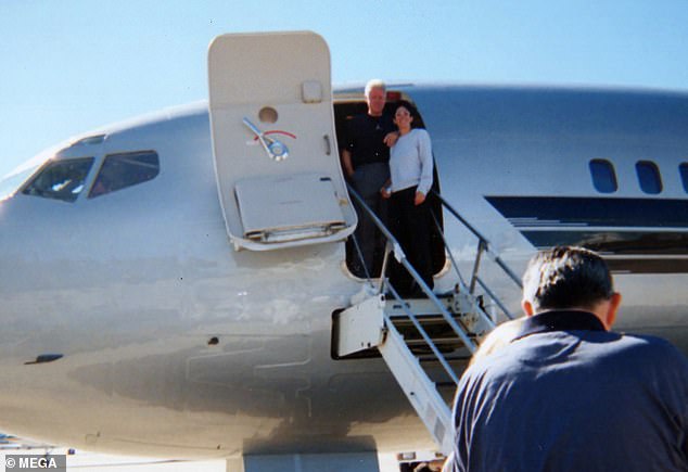 Clinton posing with Ghislaine Maxwell at the top of the stairs of Epstein's jet, dubbed the 'Lolita Express', in 2002