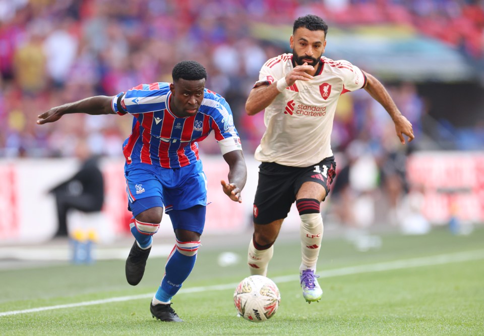 Mohamed Salah of Liverpool and Marc Guehi of Crystal Palace during a soccer match.
