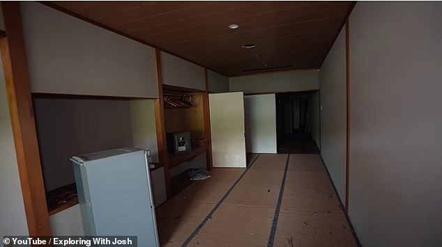 In the hotel's time-capsule rooms, wooden hangers are seen perfectly hung in wardrobes, while duvet covers remain folded on top of beds and fridges lay intact and unplugged nearby