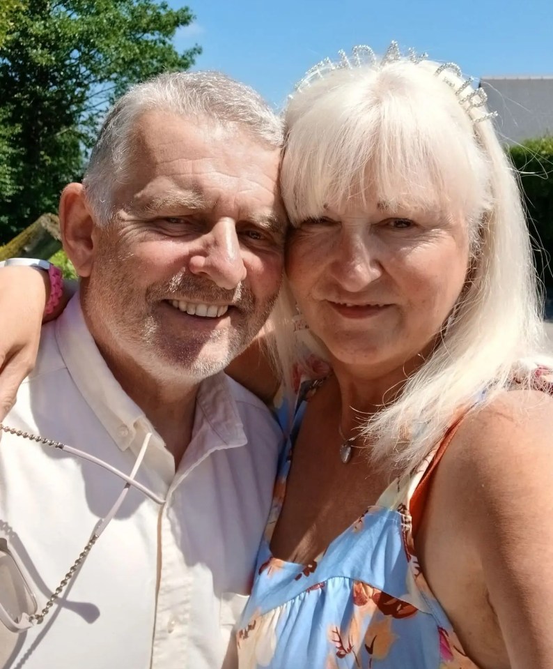 Close-up photo of a smiling older couple embracing.