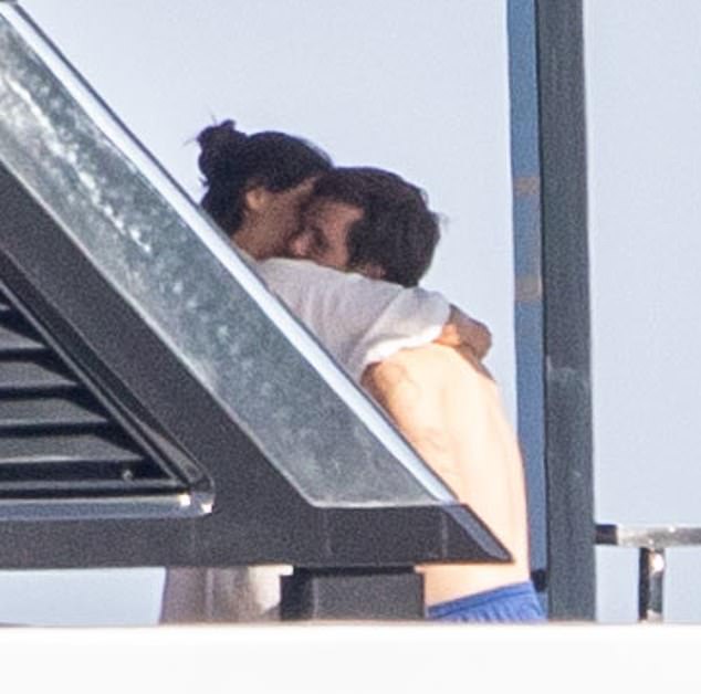 They were joined by youngest son Cruz, 20, and his gorgeous girlfriend Jackie Apostel, 29, who also packed on the PDA