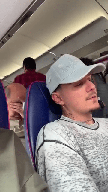 A plane passenger realizing he's sitting behind Katie Price.