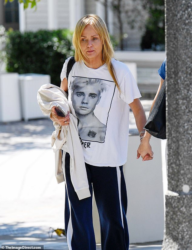Her street style look consisted of a Justin Bieber T-shirt paired with dark blue track pants and slip-on slides