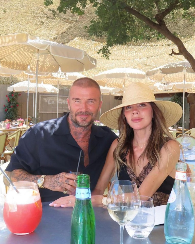 David and Victoria Beckham sitting at an outdoor table.
