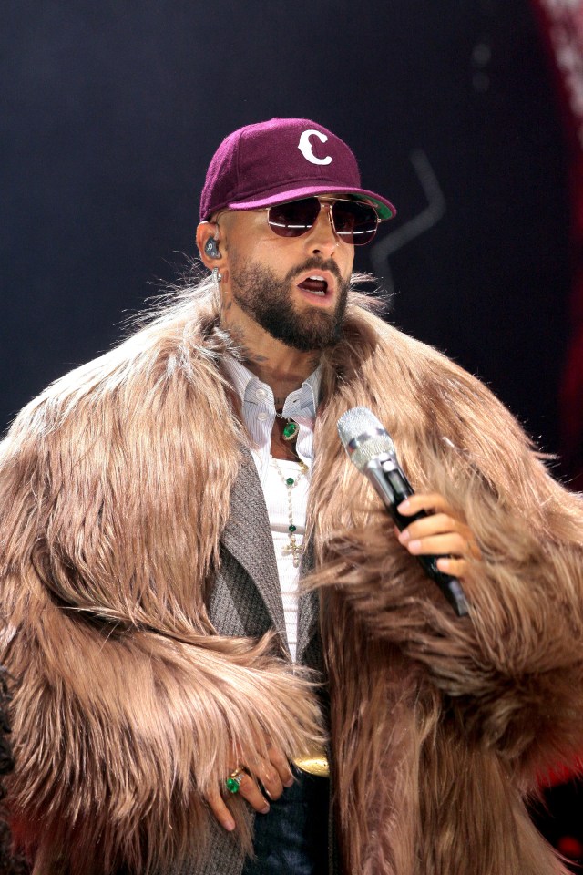 Maluma performing on stage.