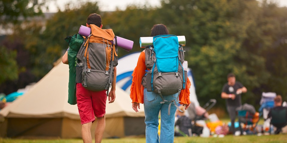 Two people with backpacks walking away from the camera.