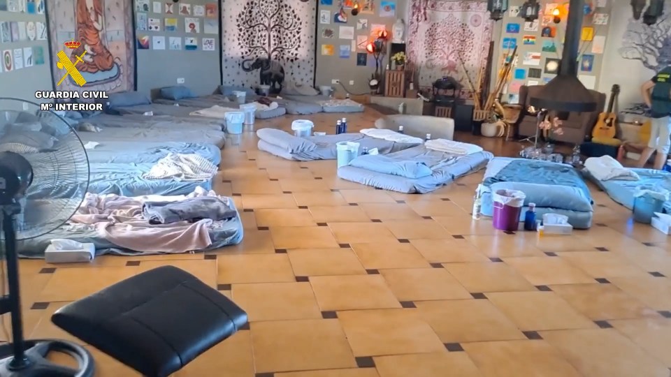 Interior of a Spanish retreat center raided by police; multiple mattresses are arranged on the floor.