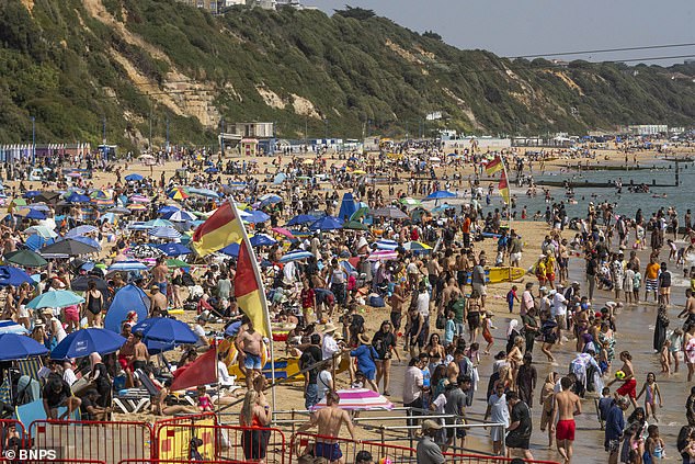 Thousands of people pack the beach in Bournemouth on Sunday as holidaymakers enjoy the golden sands and blue skies in Dorset