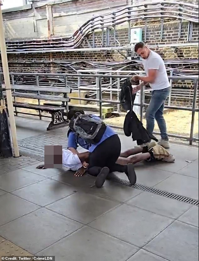 A group carried him off the train and pinned him down on the platform, waiting for help to arrive