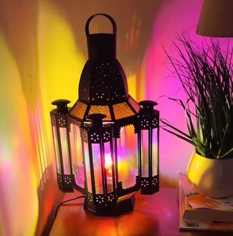 Stained-glass lantern casting colorful light on a side table.