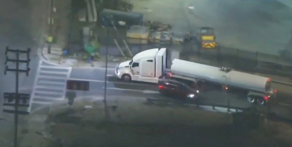 Overhead view of a police chase involving a semi-truck and other vehicles.