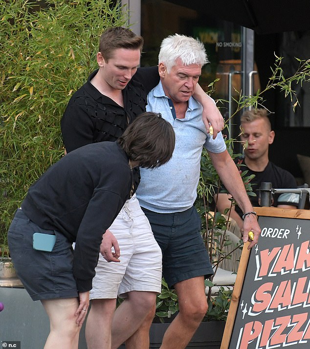 Joshua was asssisted by his famous friend while leaving the restaurant