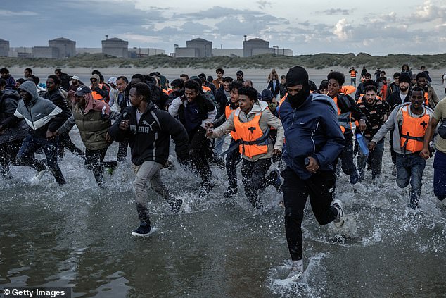 Extraordinary pictures from Gravelines beach in northern France today showed dozens of migrants rushing into the sea towards a dinghy heading to the UK