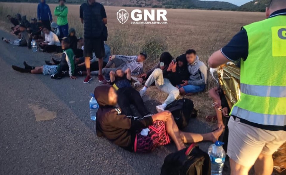 GNR officers assisting 38 rescued migrants.