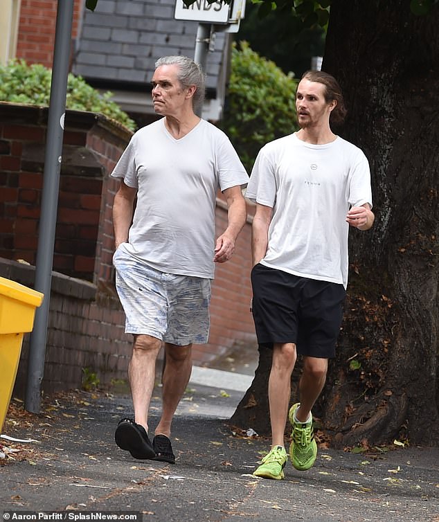 It's Stone Roses frontman Ian Brown. Now 62, he has been working on his solo career since the band confirmed their split in 2019 (pictured with his son)