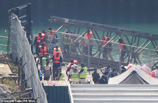 Migrants being brought ashore at Dover this morning after being picked up in the Channel