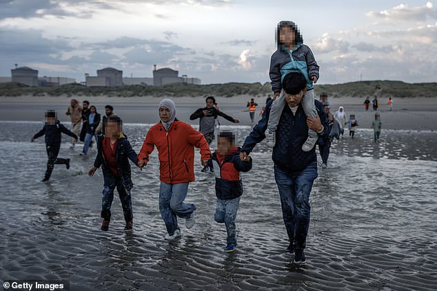 A number of women and children were also pictured attempting to board dinghies this morning