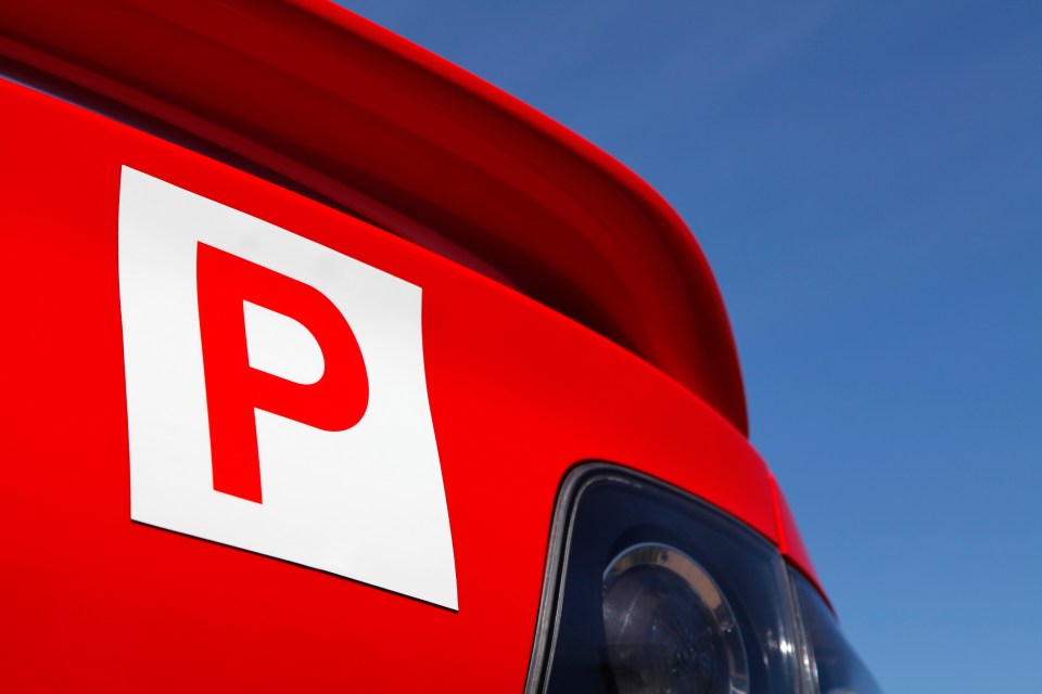 Red car with a P-plate.