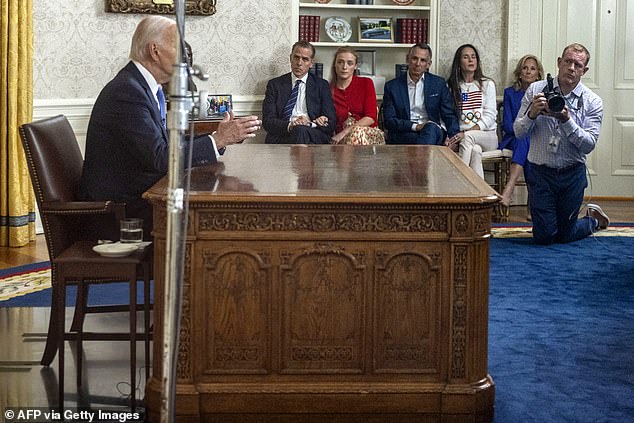 Former President Joe Biden (L) speaks during an address to the nation about his decision to not seek reelection as his son Hunter Biden (2nd L), Hunter's daughter Finnegan Biden (3rd L), Ashley Biden's husband Howard Krein, Biden's daughter Ashley Biden (3rd R) and US First Lady Jill Biden (2nd R) listen in June 2024