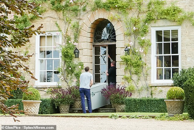 Staff bringing in Vance's suitcases and boxes as he and his family enjoy a summer in the Cotswolds