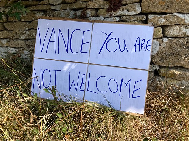But his holidaying in the area has seen left-leaning protesters flock to the area with signs telling the vice president he is not welcome (pictured)
