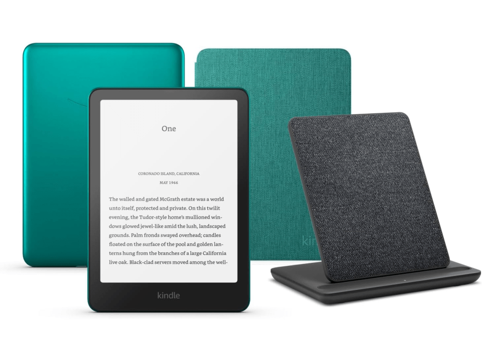 Kindle e-reader with teal and gray covers and charging stand.