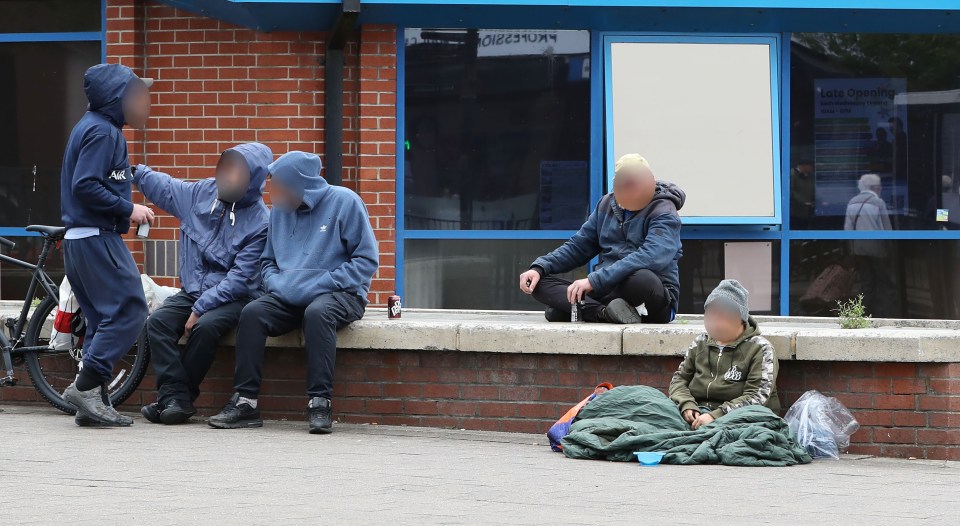 Photo of people sitting outside a building.