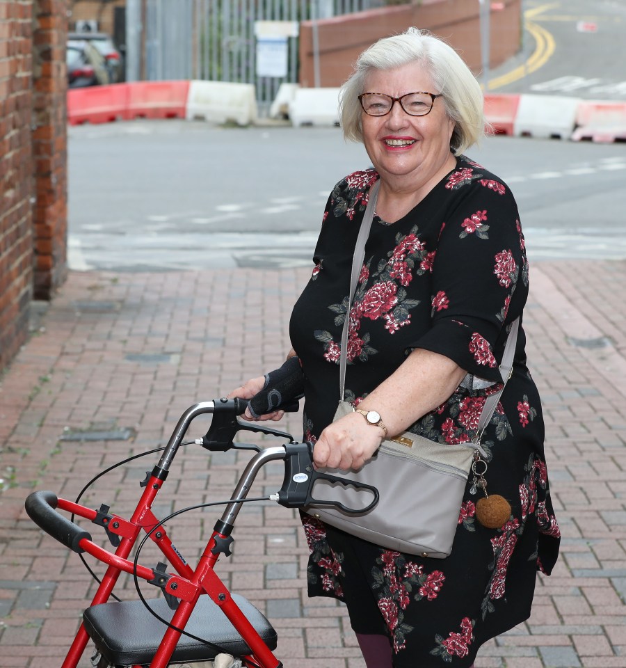 A woman using a rollator.