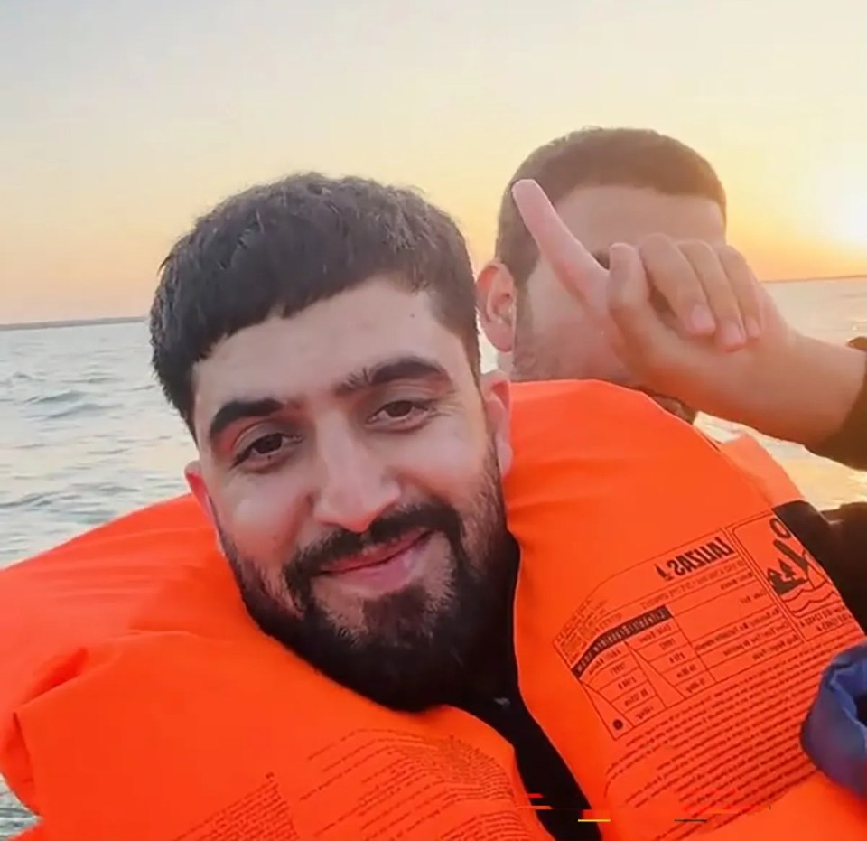 Two men wearing life vests on a boat.