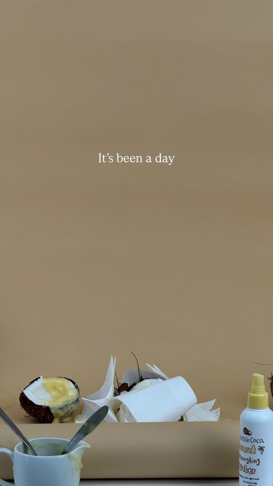 Image of coconut halves with a yellow sauce, a bottle of detangling spray, and the text "It's been a day".