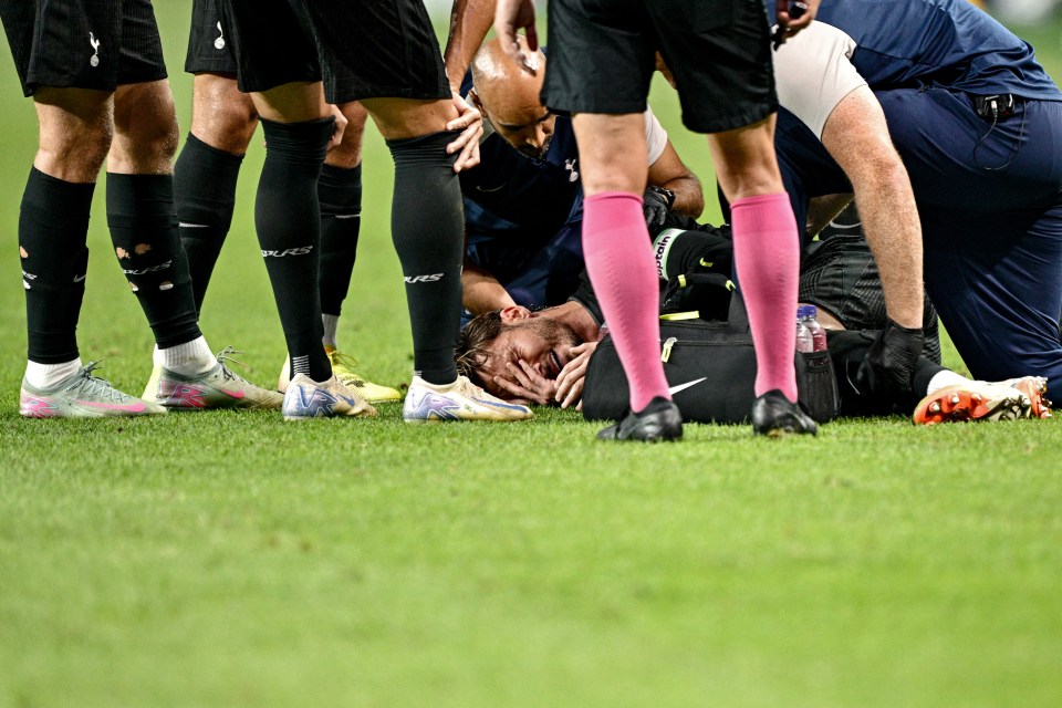 Injured soccer player being attended to on the field.