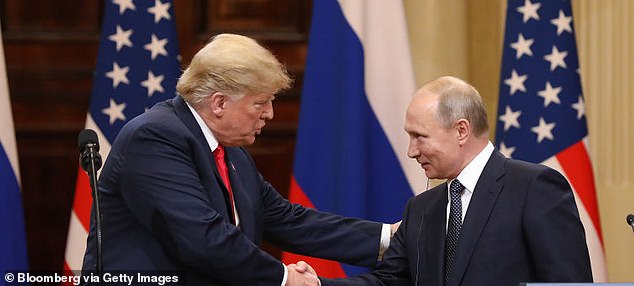 Donald Trump shakes hands with Vladimir Putin during a news conference in 2018