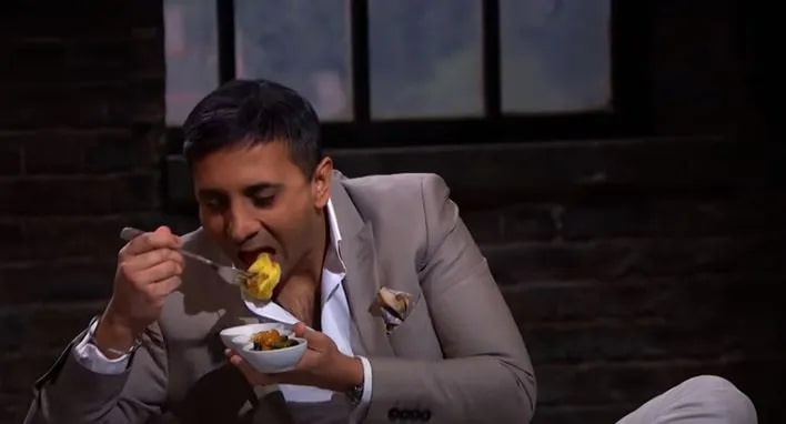 Man eating pasta on Dragons Den.