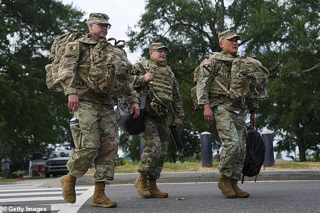 White House press secretary Karoline Leavitt said that around 850 officers and agents had fanned out across the city on Monday and made the arrests, troops are seen here on Tuesday