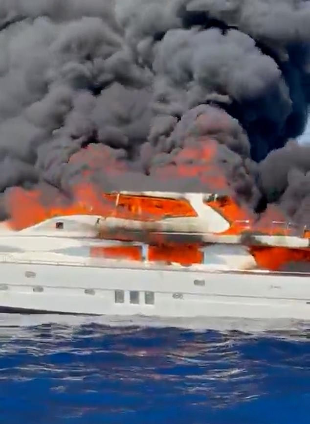 Footage taken on Monday shows the blaze tearing through the 28-meter vessel as a huge plume of dark grey smoke rises into the sky