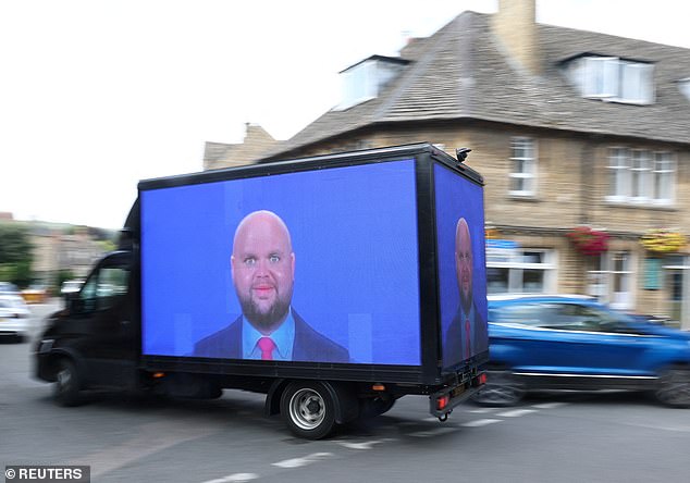 A van, displaying meme imagery of U.S. Vice President JD Vance, organised by the campaign group Everyone Hates Elon, travels through the town of Charlbury