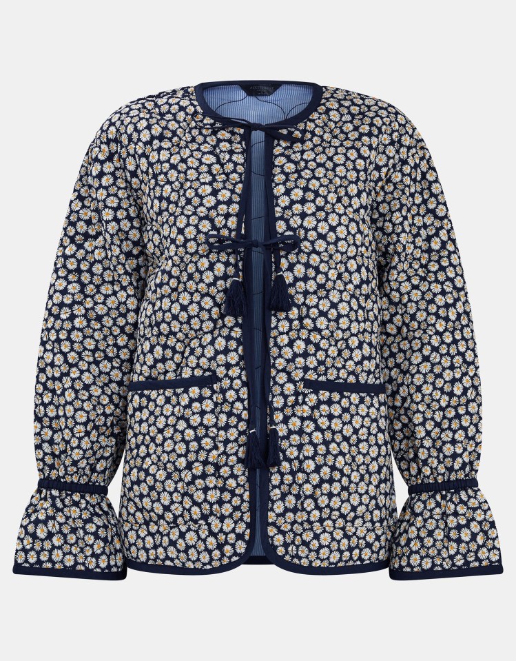 Navy blue daisy print quilted jacket with bell sleeves and tassels.