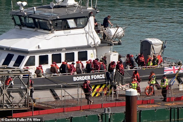 Pictured: A group of people thought to be migrants are brought in to the Border Force compound in Dover, Kent, from a Border Force vessel following a small boat incident in the Channel