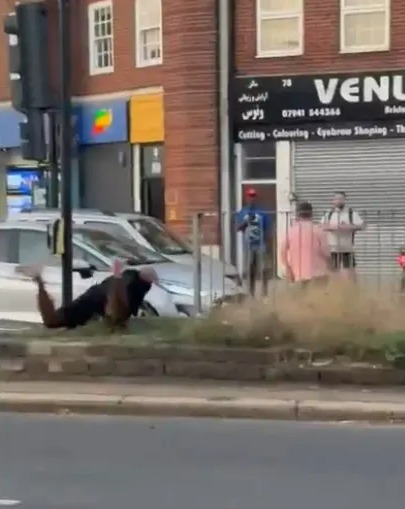 Person on ground during a road rage incident.