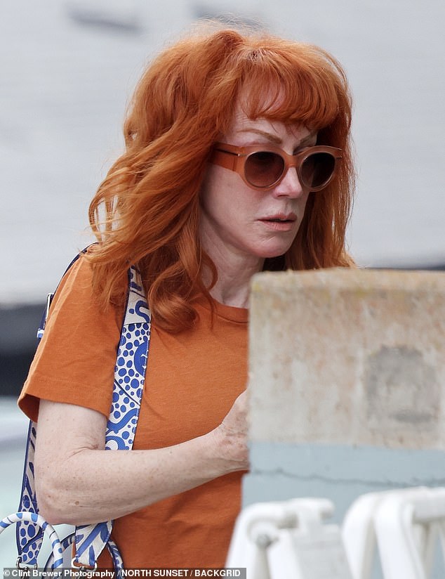 Kathy wore an orange T-shirt with the slogan 'Adopt, don't shop,' navy leggings, and black flats for the outing