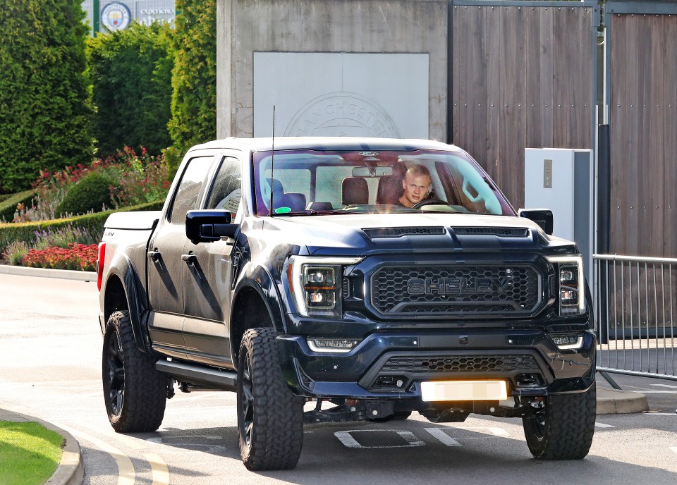 Erling Haaland driving a Ford F150 Shelby monster truck through a gate.