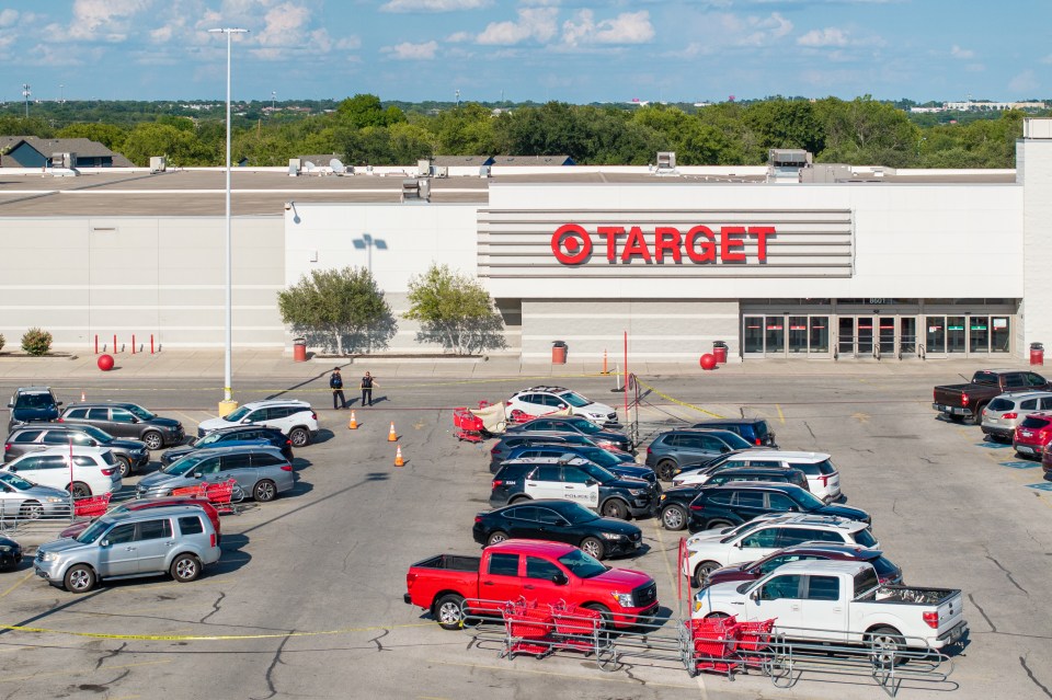 Aerial view of a Target store parking lot in Austin, Texas, with police cars and officers at the scene of a shooting.