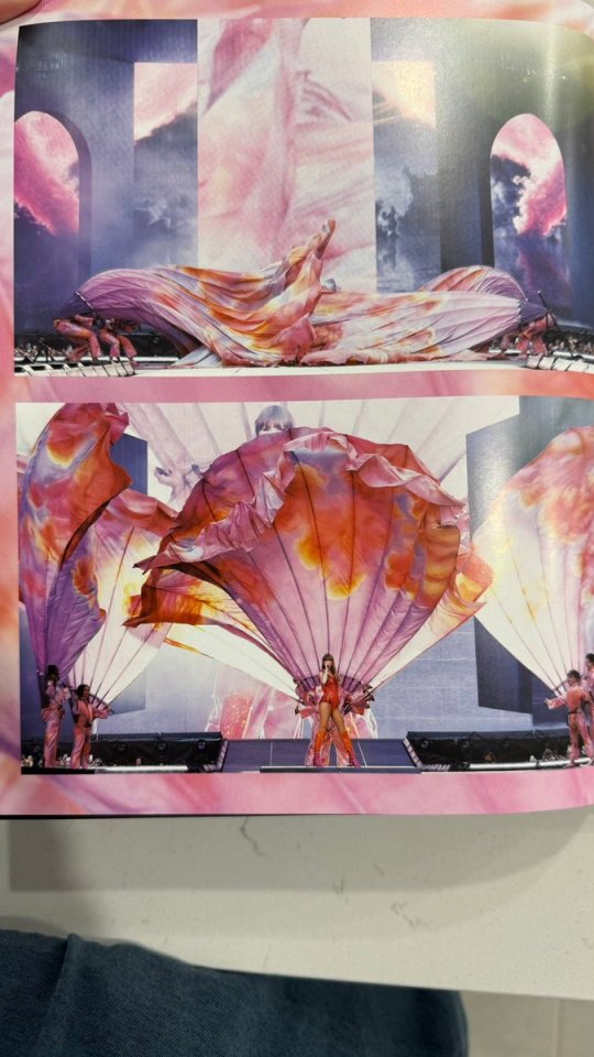 Photos from Taylor Swift's Eras Tour book showing a stage performance with large pink fabric props.